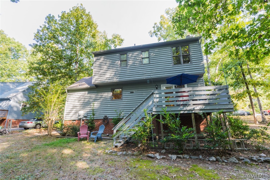 10319 Natural Bridge Road Chesterfield, VA 23236 - Photo 25 of 25 a backyard of a house with table and chairs a barbeque and a large tree