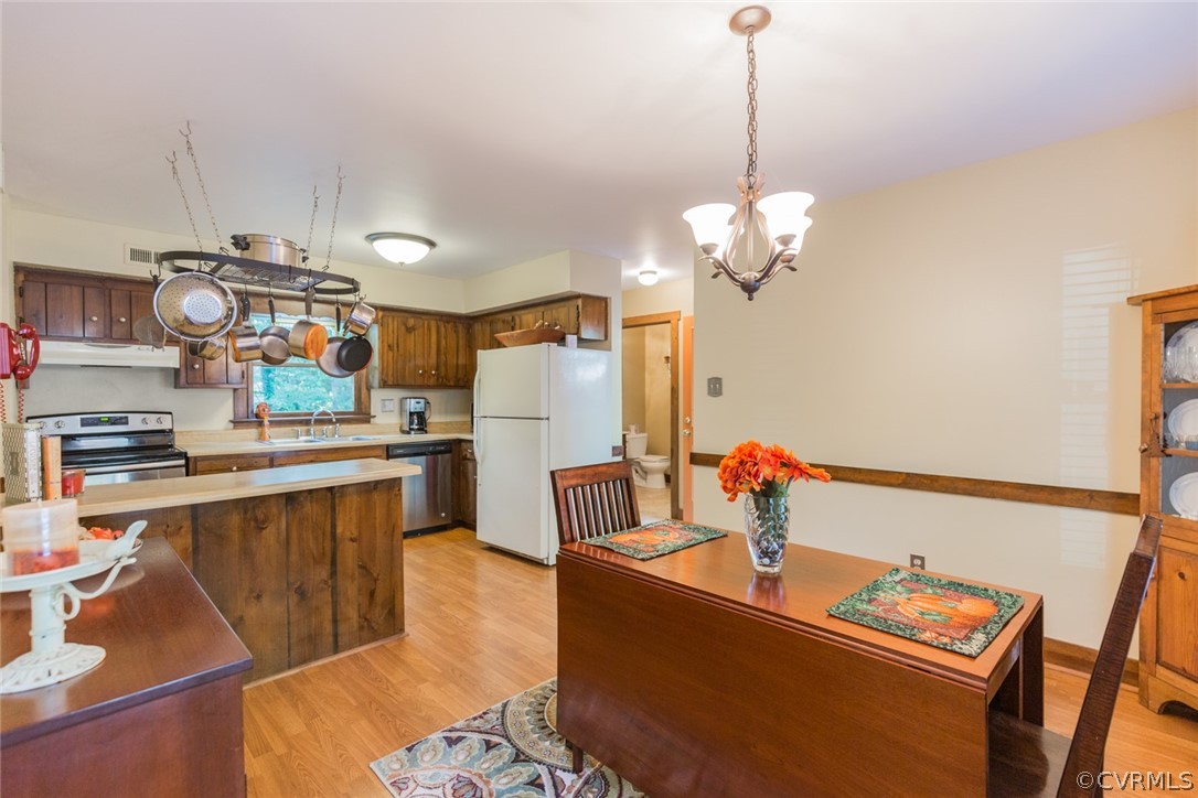 10319 Natural Bridge Road Chesterfield, VA 23236 - Photo 6 of 25 a kitchen with stainless steel appliances granite countertop a sink dishwasher a stove and a refrigerator with wooden floor
