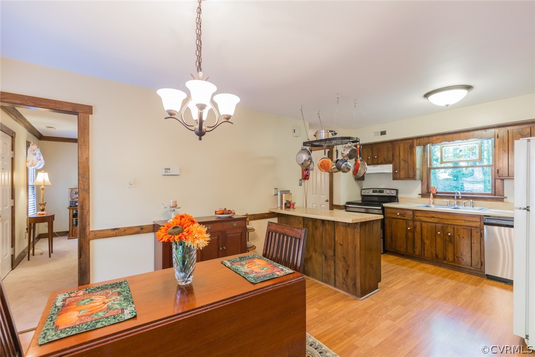 10319 Natural Bridge Road Chesterfield, VA 23236 - Photo 7 of 25 a very nice looking dining room with kitchen island granite countertop wooden floor a large window and a sink