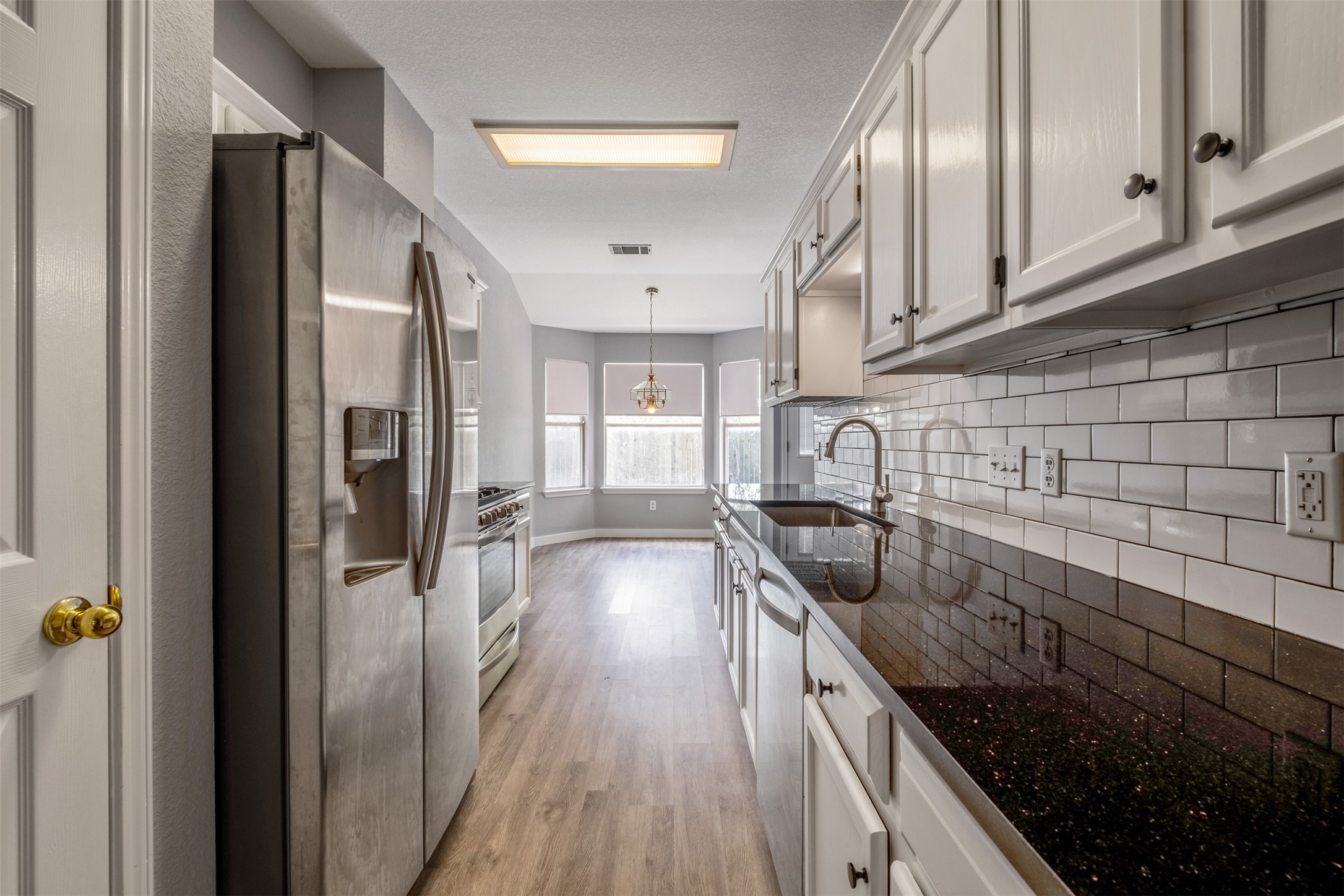 3413 Ruby Red Drive Austin, TX 78728 - Photo 10 of 19 A well-appointed kitchen features stainless steel appliances, ample cabinetry, and a bright breakfast nook with bay windows.