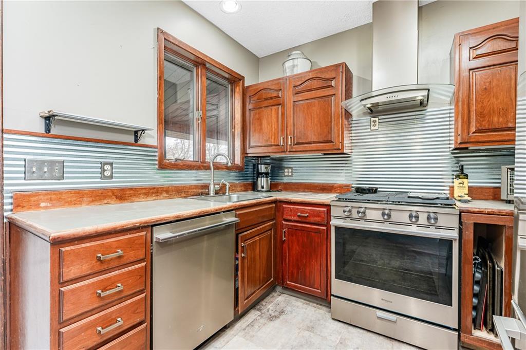 162 Big Dog Road Waynesburg, PA 15370 - Photo 11 of 50 a kitchen with stainless steel appliances granite countertop a stove and a sink