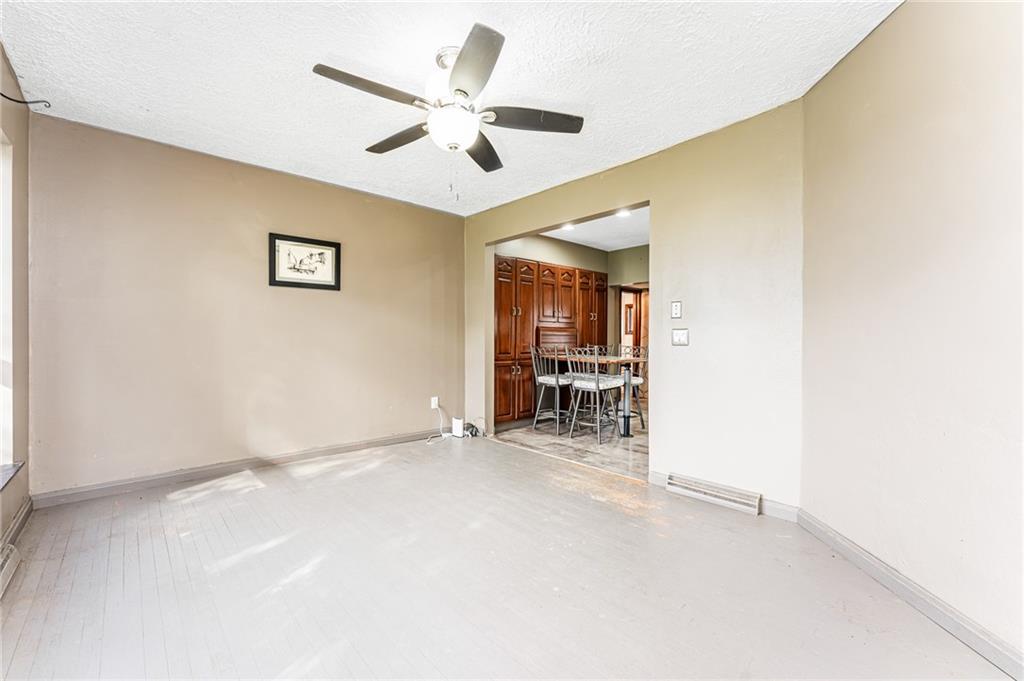 162 Big Dog Road Waynesburg, PA 15370 - Photo 6 of 50 an empty room with windows and a ceiling fan