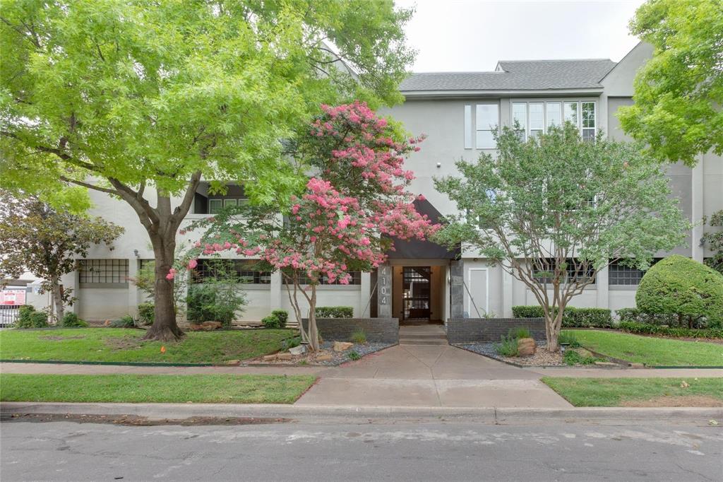 4104 North Hall Street, Unit 102 Dallas, TX 75219 - Photo 3 of 18 Stucco-finish exterior with a dark-pitched roofline and multiple window treatments