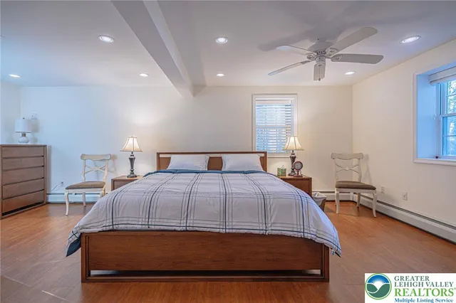a living room with furniture a rug a fireplace and a large window