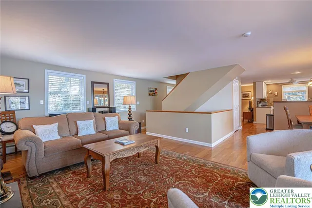 a kitchen with stainless steel appliances granite countertop a stove a sink and a refrigerator with wooden cabinets