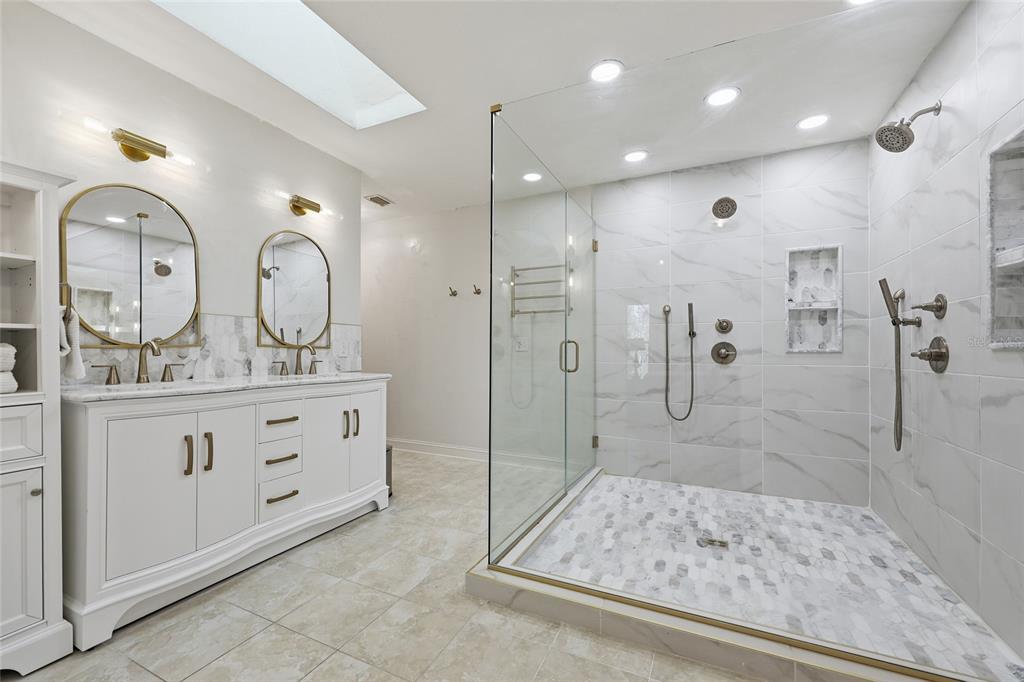 6612 Northwest 44th Place Gainesville, FL 32606 - Photo 19 of 34 a bathroom with a double vanity sink mirror and shower