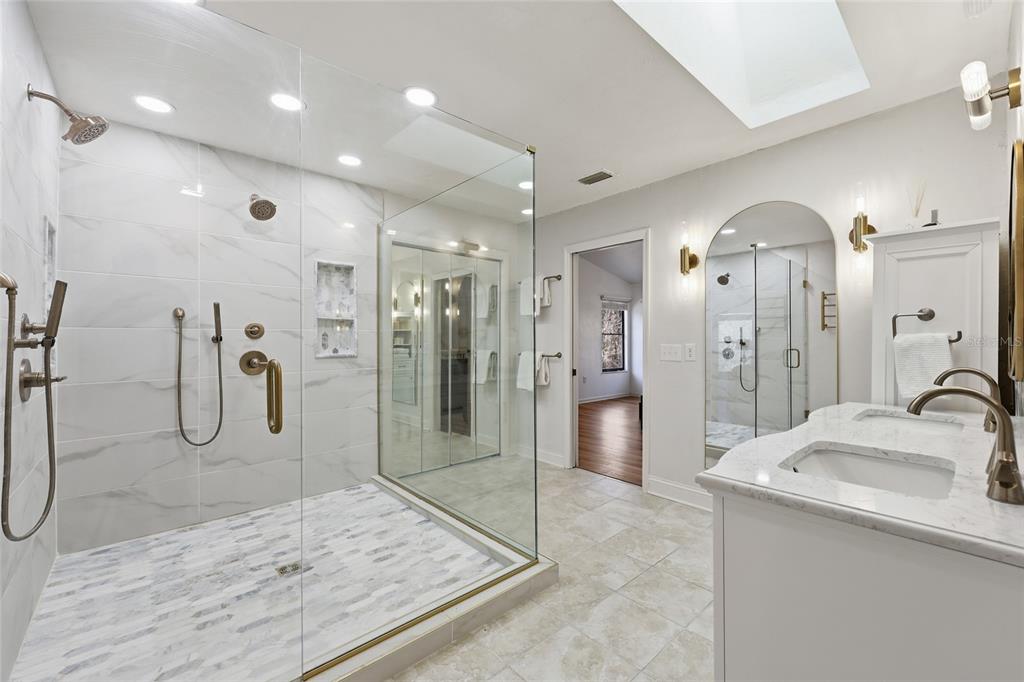 6612 Northwest 44th Place Gainesville, FL 32606 - Photo 20 of 34 a bathroom with a sink a toilet a mirror and shower