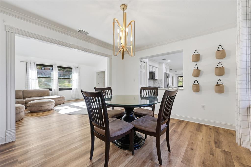 6612 Northwest 44th Place Gainesville, FL 32606 - Photo 7 of 34 a view of a dining room with furniture and wooden floor