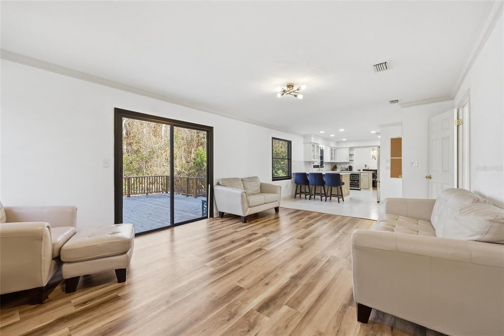 6612 Northwest 44th Place Gainesville, FL 32606 - Photo 10 of 34 a living room with furniture and a table with wooden floor