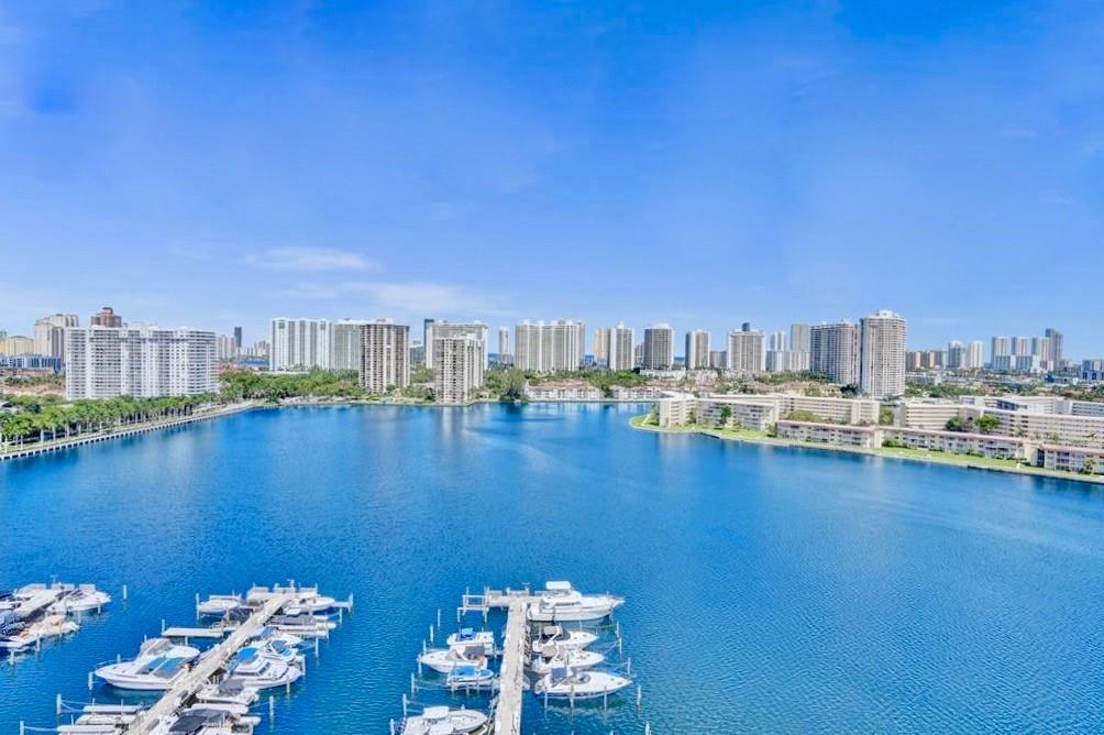 18031 Biscayne Boulevard, Unit 1104 Aventura, FL 33160 - Photo 1 of 35 a view of a lake with boats in front of house