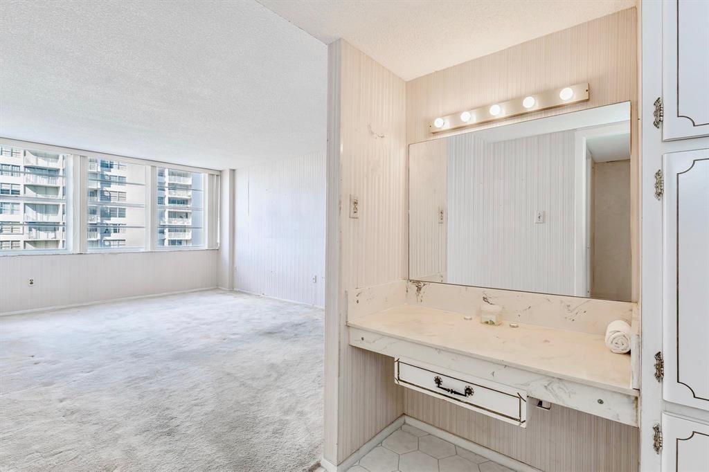 18031 Biscayne Boulevard, Unit 1104 Aventura, FL 33160 - Photo 13 of 35 a bathroom with a granite countertop sink mirror and a bathtub