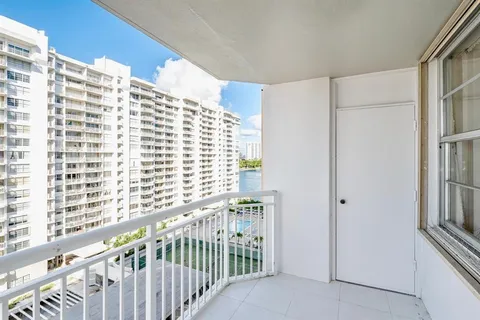 a view of a balcony with wooden floor