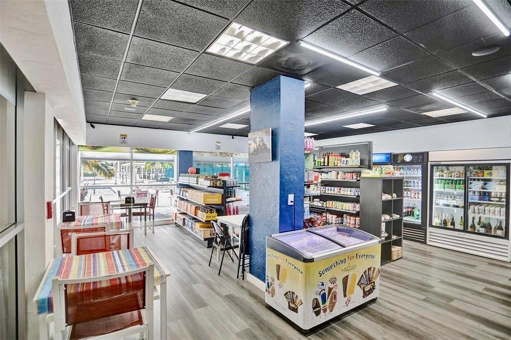 18031 Biscayne Boulevard, Unit 1104 Aventura, FL 33160 - Photo 23 of 35 a room with lots of wooden furniture and a book shelf