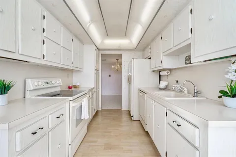 a kitchen with cabinets and window