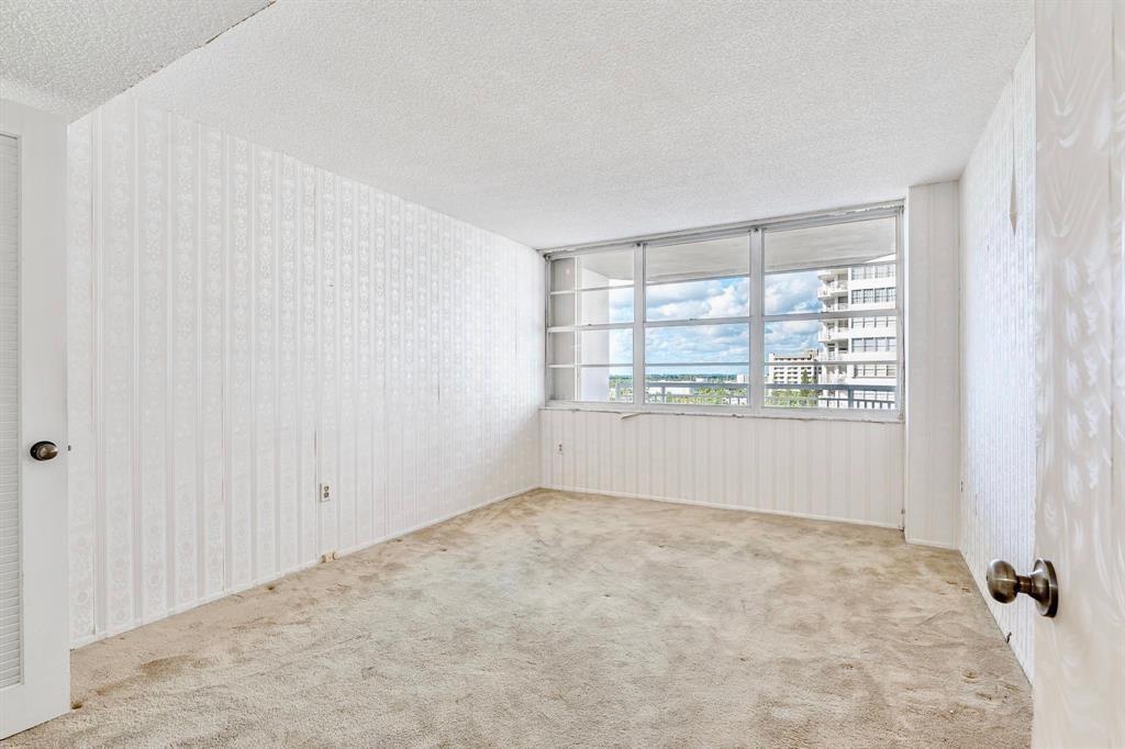 18031 Biscayne Boulevard, Unit 1104 Aventura, FL 33160 - Photo 10 of 35 a view of an empty room with a window