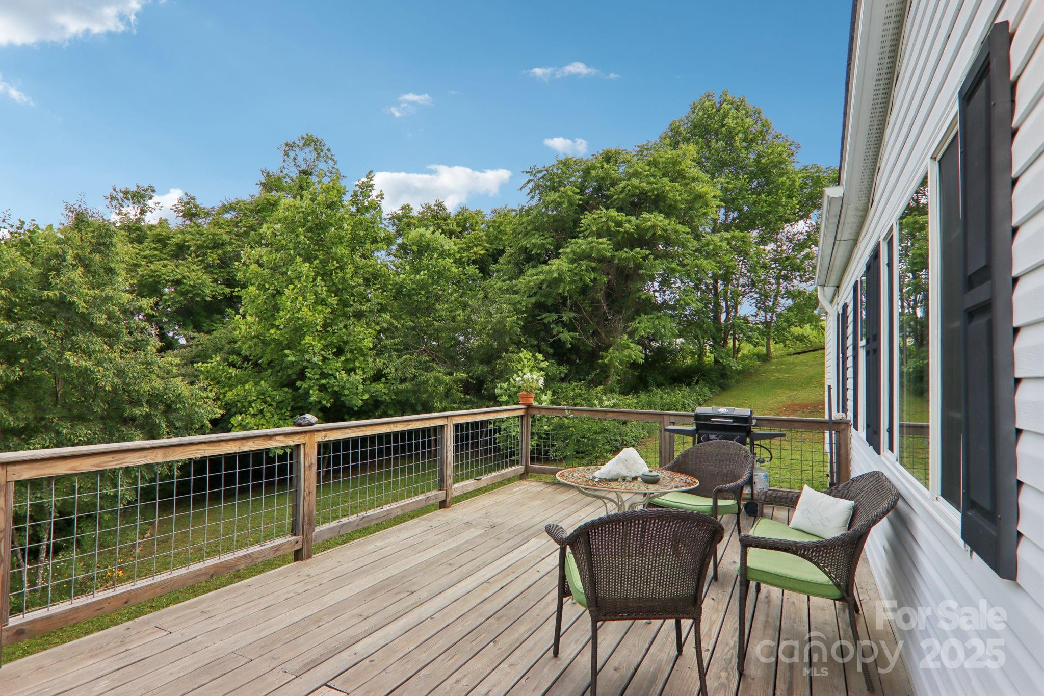 1282 Spicer Cove Road Hendersonville, NC 28792 - Photo 25 of 42 a view of chair and table in the balcony