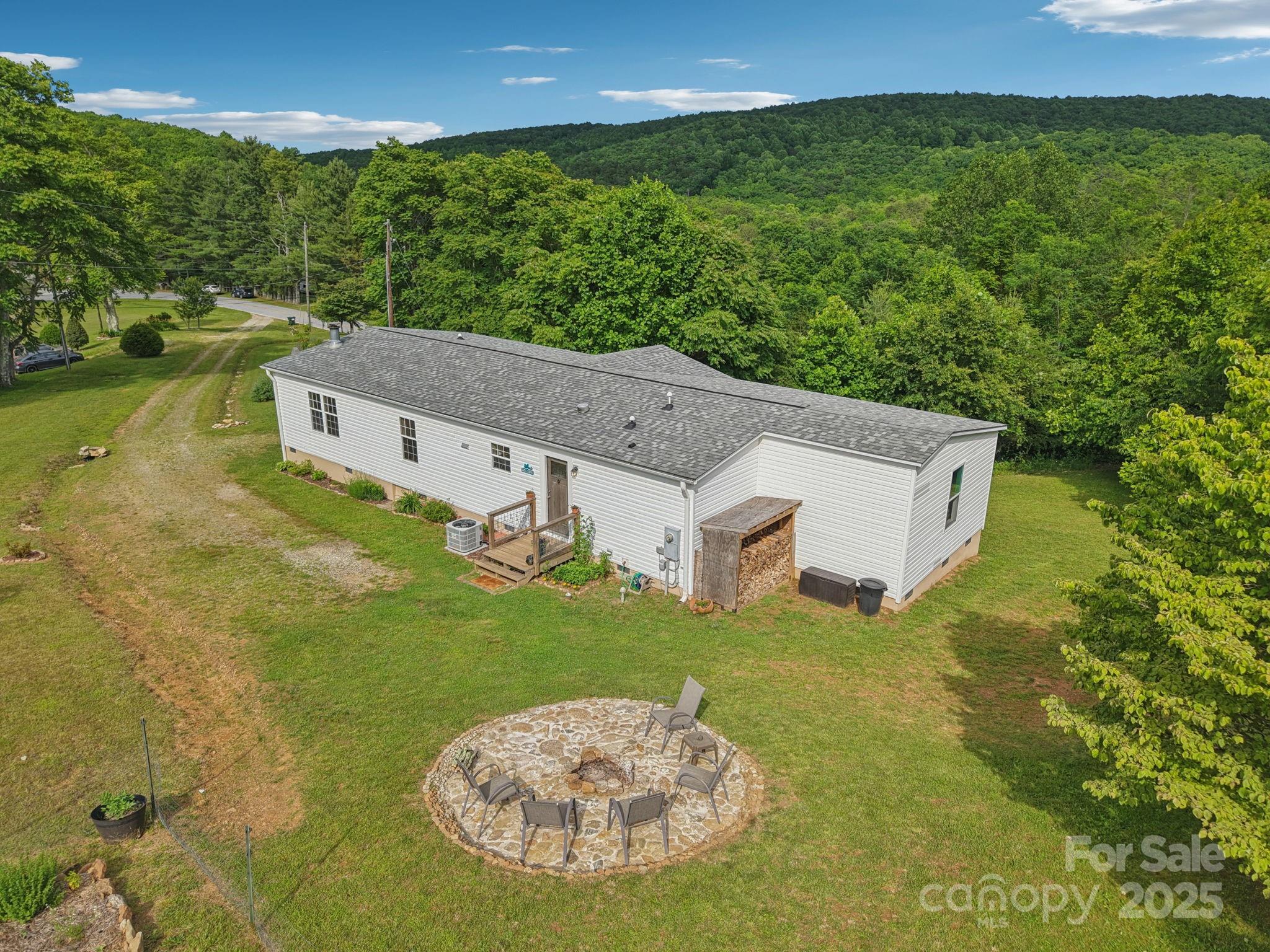 1282 Spicer Cove Road Hendersonville, NC 28792 - Photo 30 of 42 a view of a house with a big yard