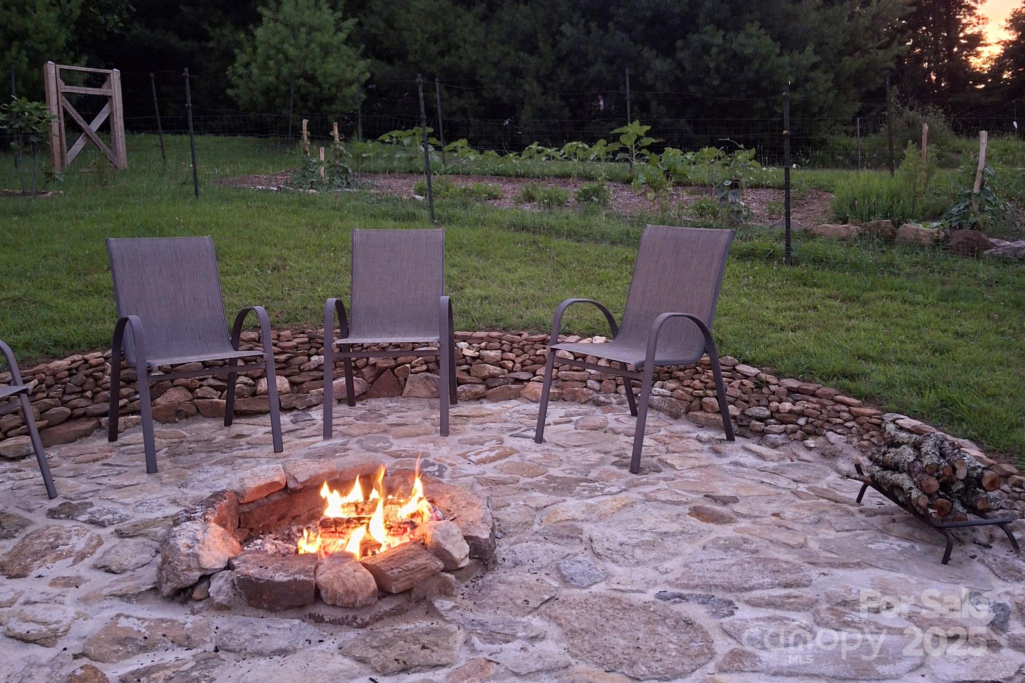 1282 Spicer Cove Road Hendersonville, NC 28792 - Photo 32 of 42 a view of a patio with chairs and a yard