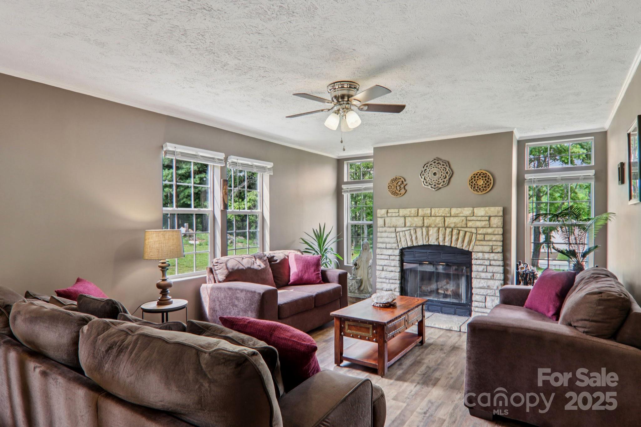 1282 Spicer Cove Road Hendersonville, NC 28792 - Photo 4 of 42 a living room with furniture a fireplace and a large window