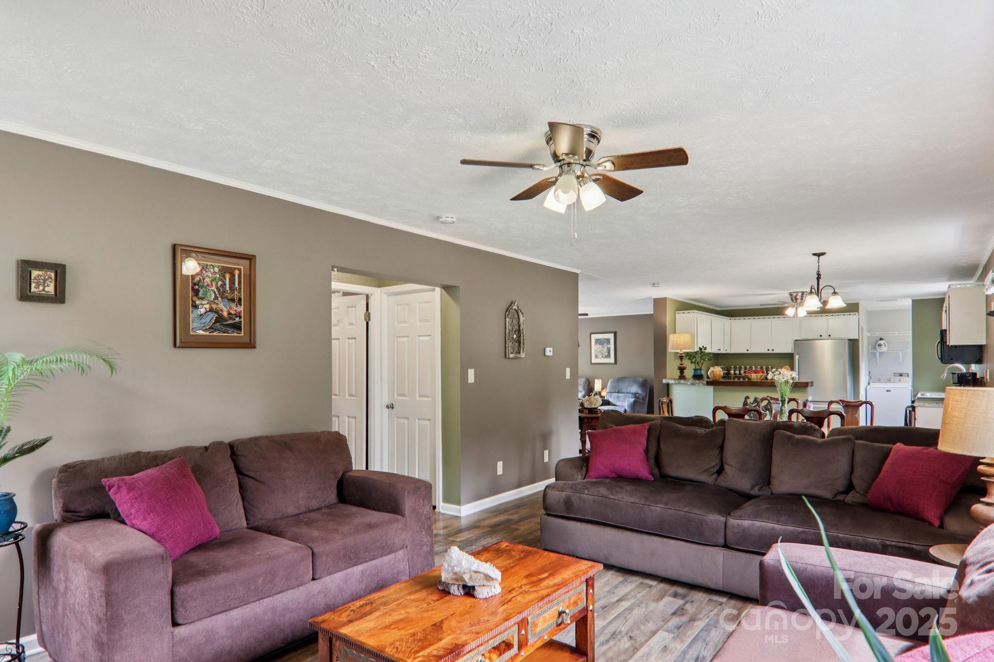 1282 Spicer Cove Road Hendersonville, NC 28792 - Photo 5 of 42 a living room with furniture ceiling fan and a rug