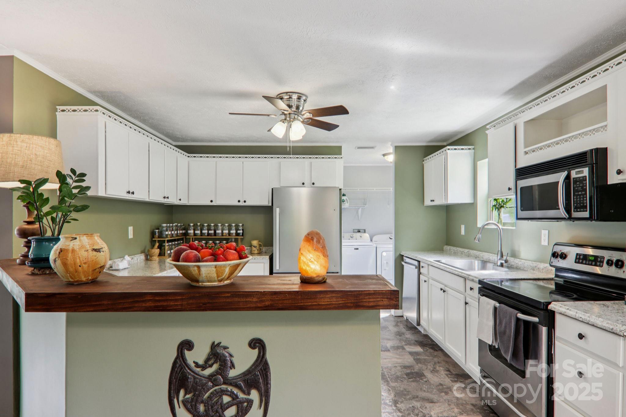 1282 Spicer Cove Road Hendersonville, NC 28792 - Photo 6 of 42 a kitchen with stainless steel appliances a stove a sink and cabinets