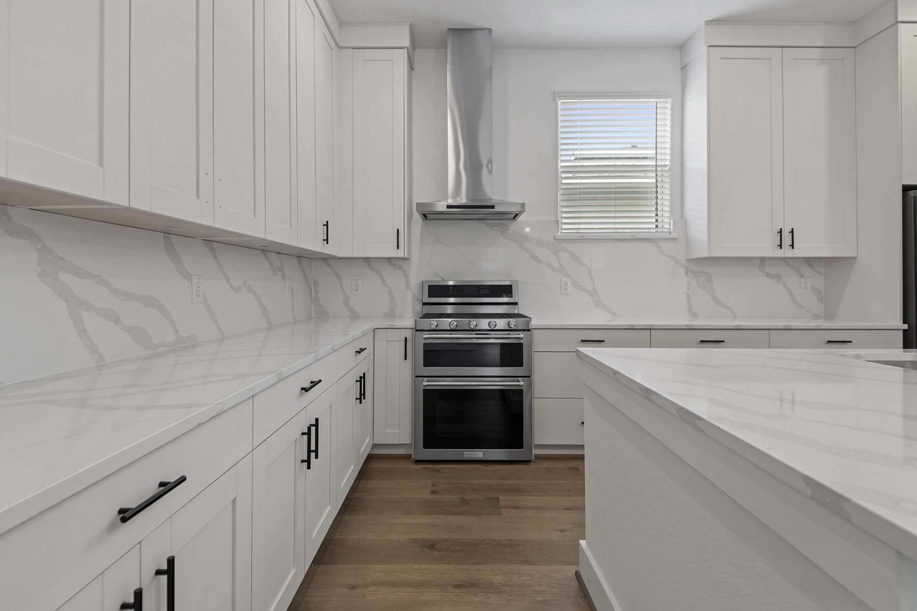 1911 Drover Lane Rosenberg, TX 77471 - Photo 8 of 22 a kitchen with white cabinets sink and stainless steel appliances