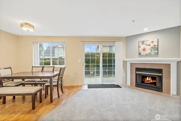 a view of a livingroom with furniture a fireplace and wooden floor