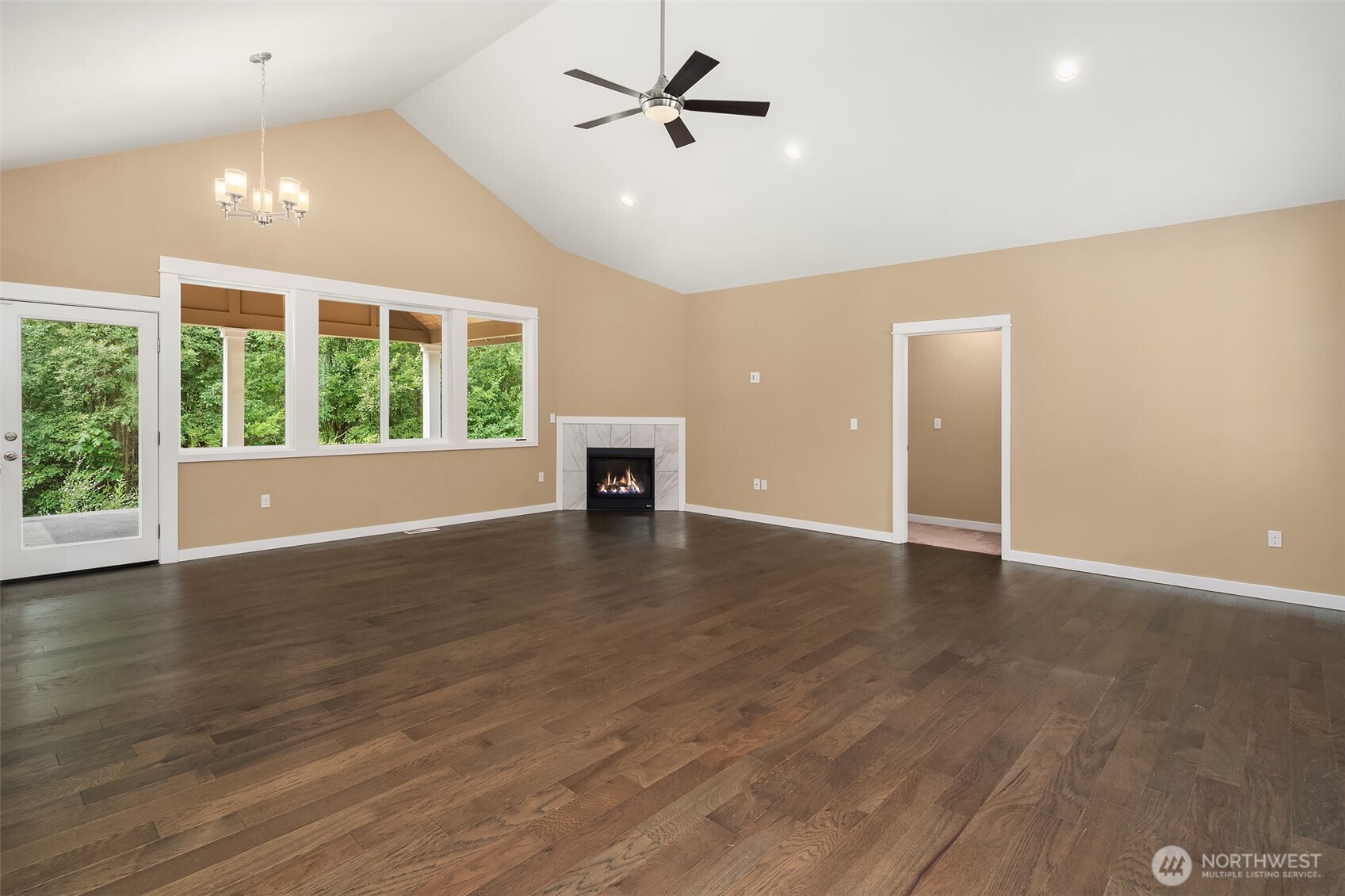 216 Cornwall Road Northwest Lakebay, WA 98349 - Photo 16 of 34 an empty room with wooden floor and windows