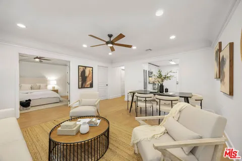a living room with furniture a window and a table