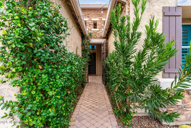 a kitchen with stainless steel appliances kitchen island granite countertop a refrigerator a stove a sink a dining table and chairs with wooden floor