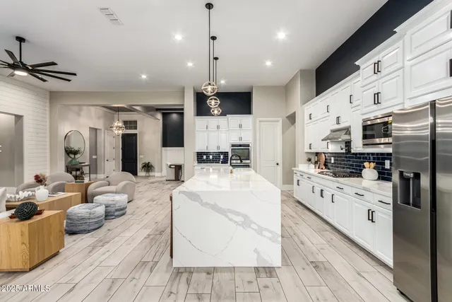 a spacious bathroom with a double vanity sink a mirror and a bathtub