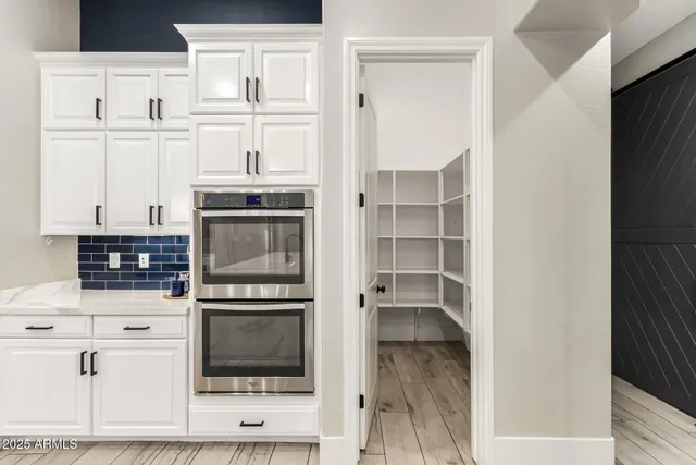 an empty room with a window and ceiling fan