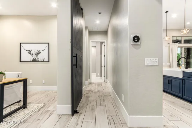 a view of an empty room with a flat screen tv and a window