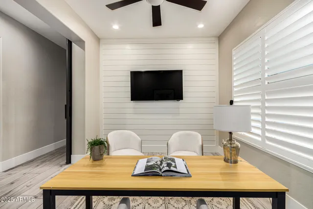 an empty room with a ceiling fan and a window