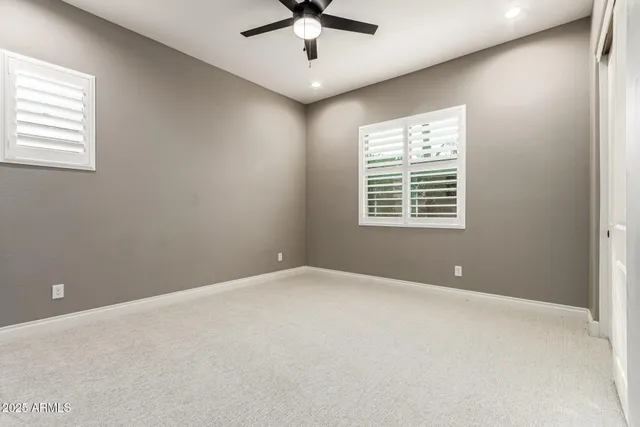 a view of a ocean with boats and trees in the background