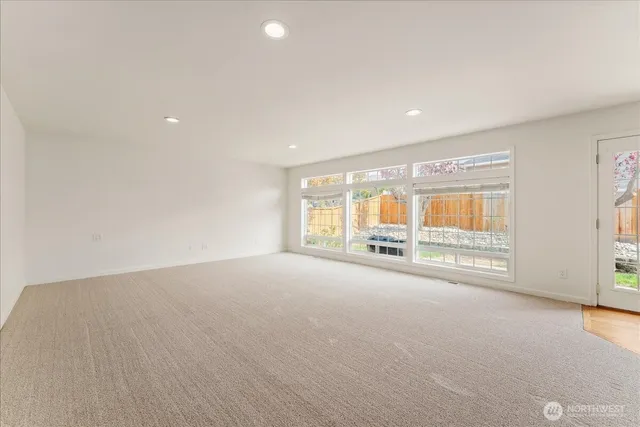 a view of an empty room with a window and balcony view
