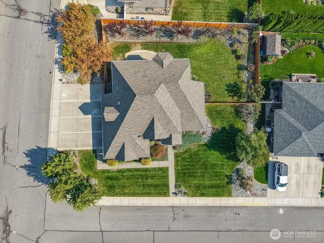 a aerial view of a house with a yard and potted plants