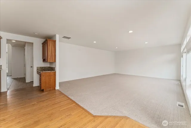a view of a kitchen with a sink and a refrigerator