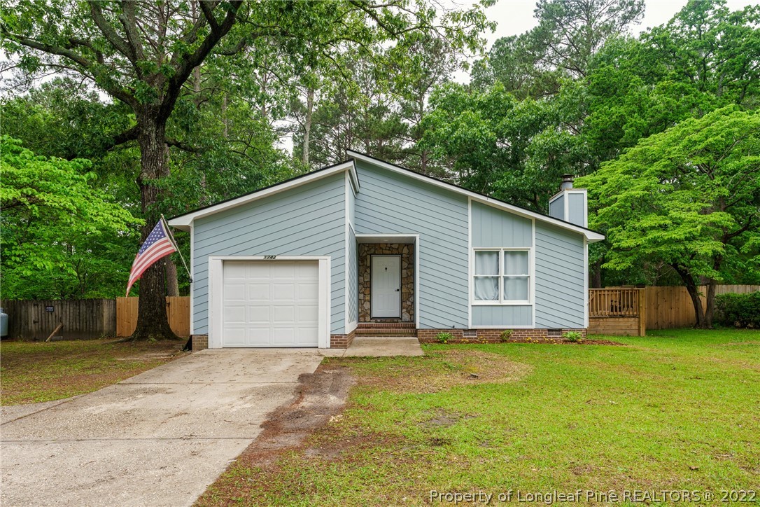 a front view of house with yard and trees