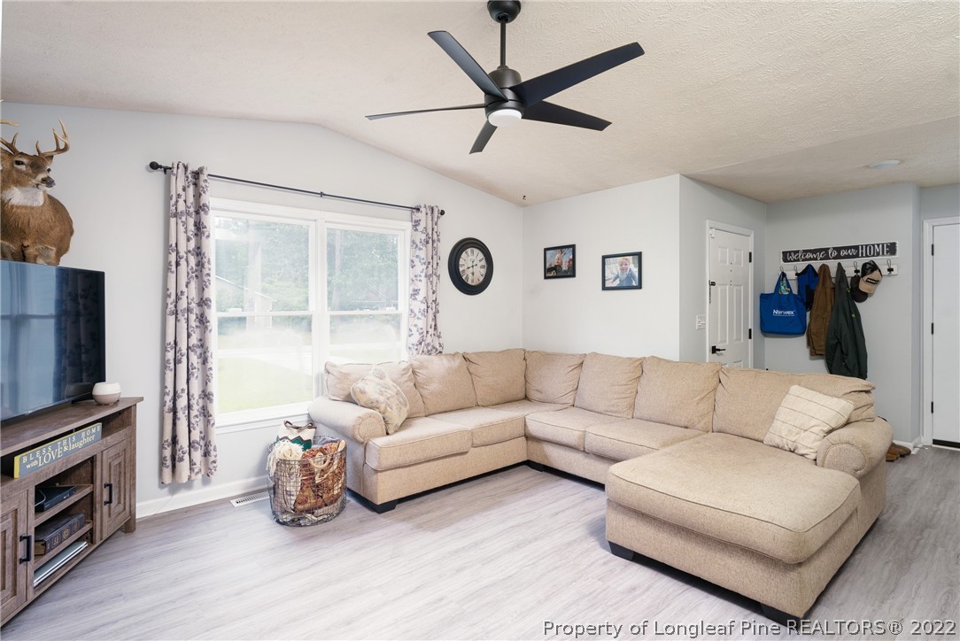 1742 Rim Road Fayetteville, NC 28314 - Photo 11 of 21 a living room with furniture and a flat screen tv