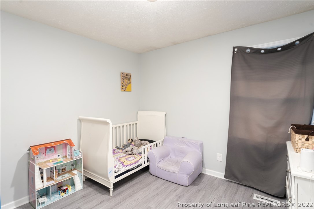 1742 Rim Road Fayetteville, NC 28314 - Photo 16 of 21 a bedroom with a bed and a mirror