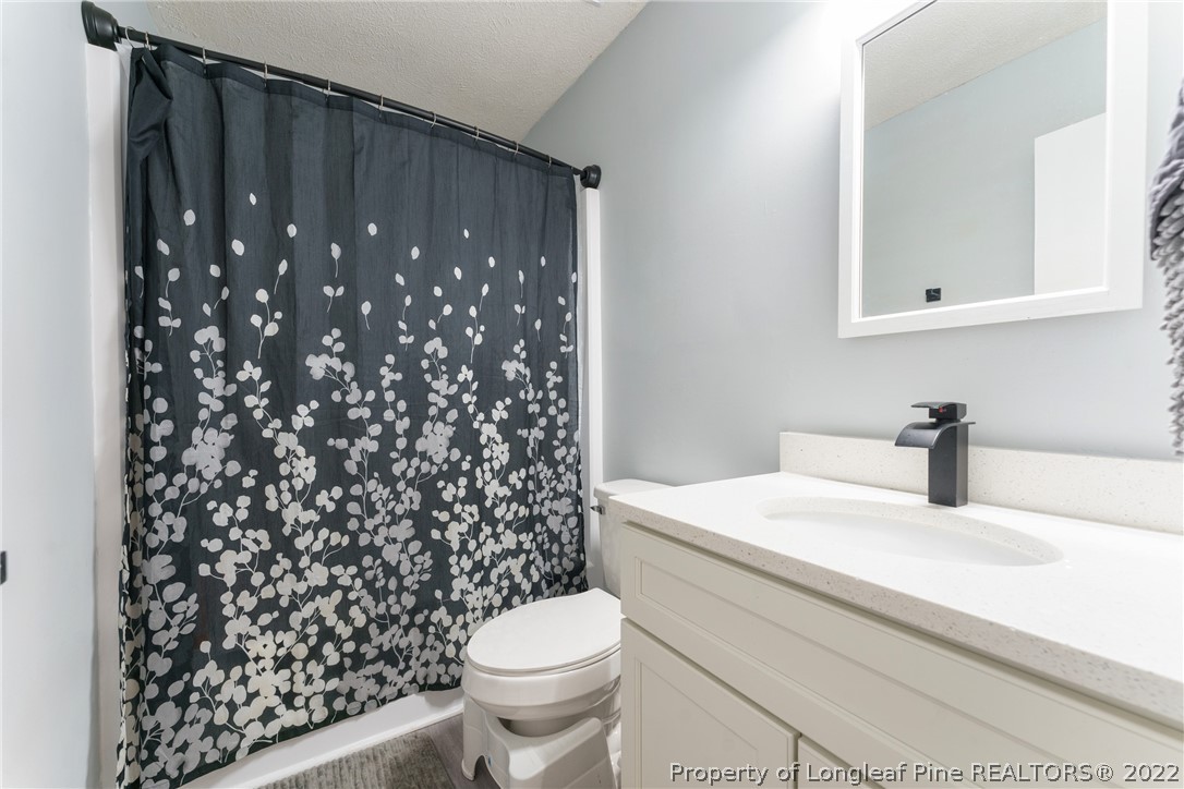 1742 Rim Road Fayetteville, NC 28314 - Photo 18 of 21 a bathroom with a sink toilet and shower