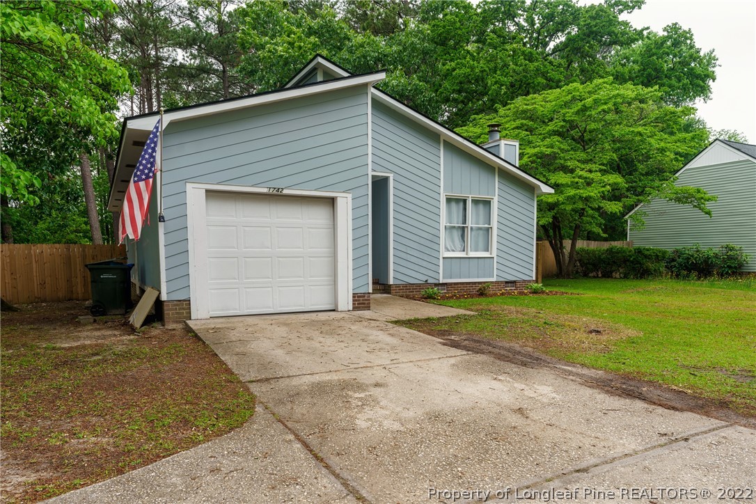 1742 Rim Road Fayetteville, NC 28314 - Photo 4 of 21 a view of backyard of house garage with small yard