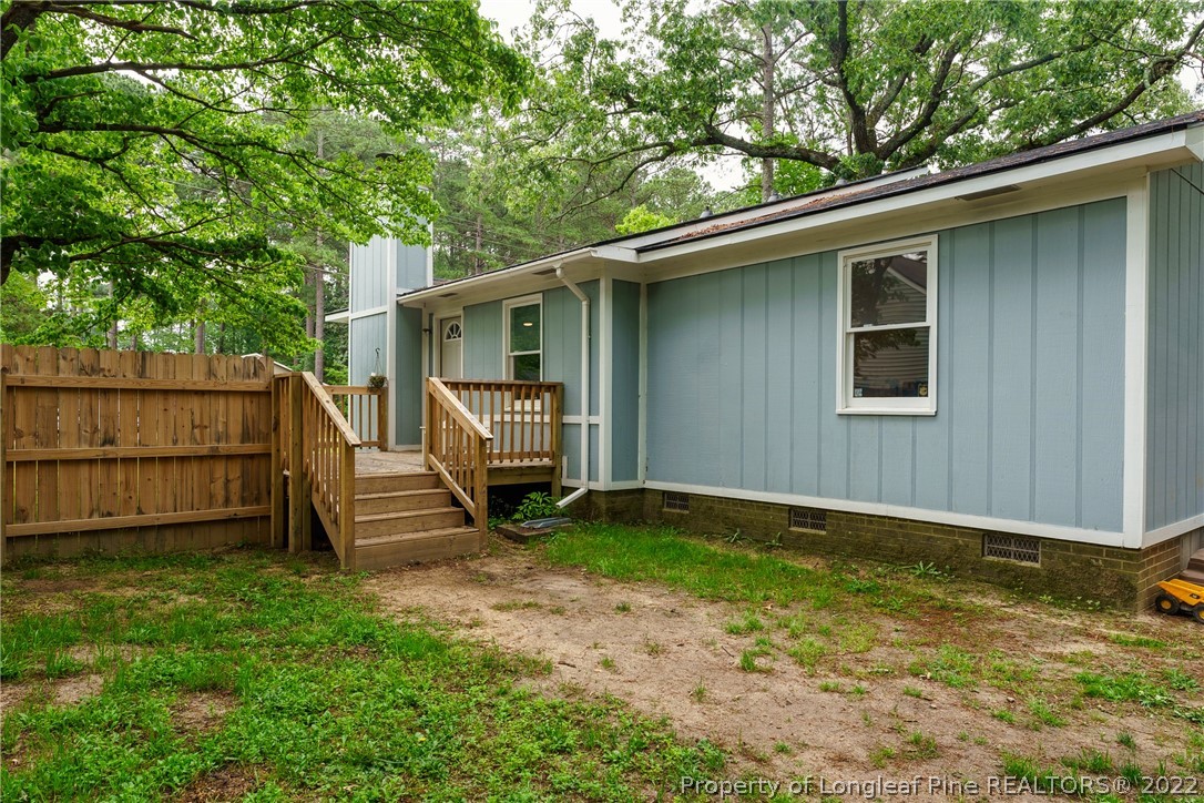 1742 Rim Road Fayetteville, NC 28314 - Photo 7 of 21 a view of backyard with a large tree and wooden fence