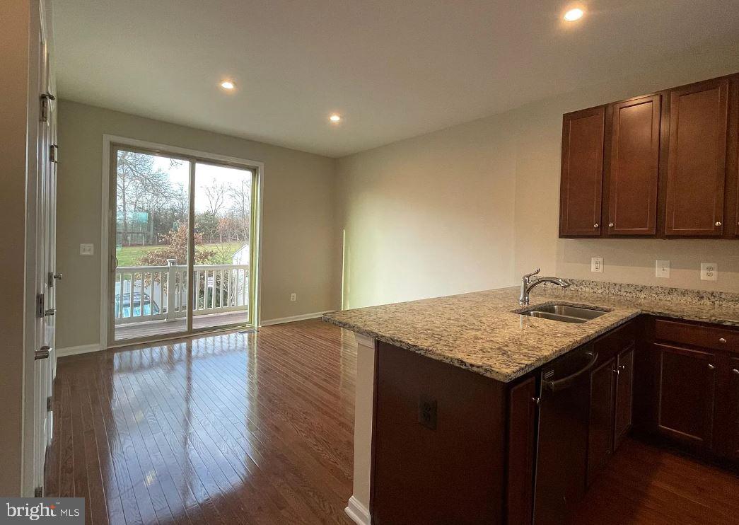 43855 Stubble Cor Square Ashburn, VA 20147 - Photo 3 of 38 a kitchen with a sink a stove cabinets and wooden floor