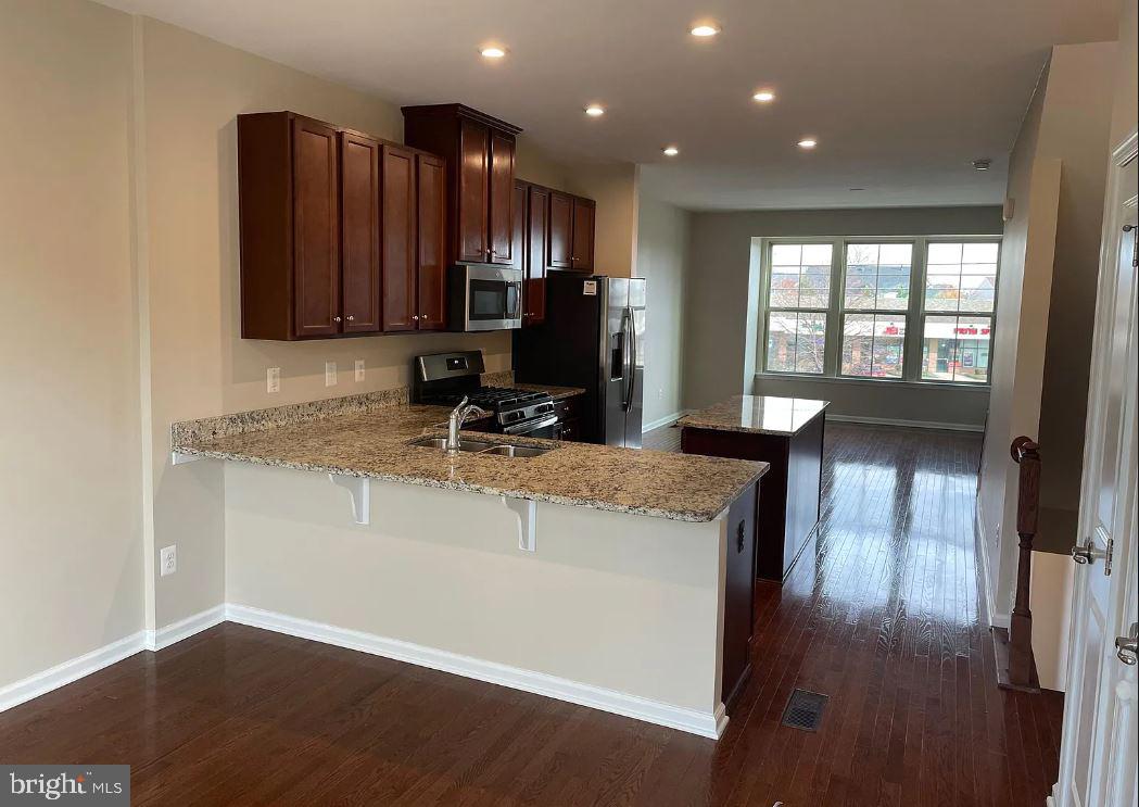 43855 Stubble Cor Square Ashburn, VA 20147 - Photo 4 of 38 a kitchen with a sink a counter top space and cabinets