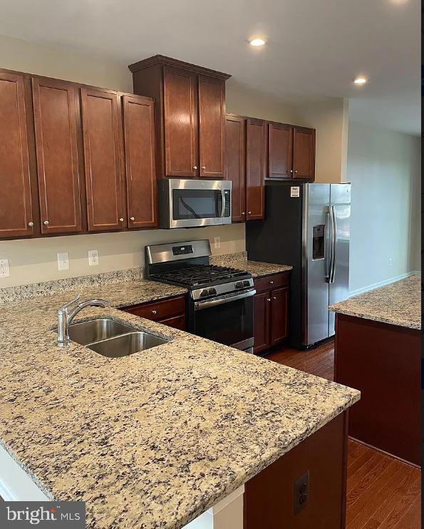 43855 Stubble Cor Square Ashburn, VA 20147 - Photo 5 of 38 a kitchen with stainless steel appliances granite countertop a sink stove and refrigerator