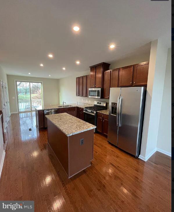 43855 Stubble Cor Square Ashburn, VA 20147 - Photo 6 of 38 a kitchen with stainless steel appliances granite countertop a refrigerator a sink a stove and a wooden floors