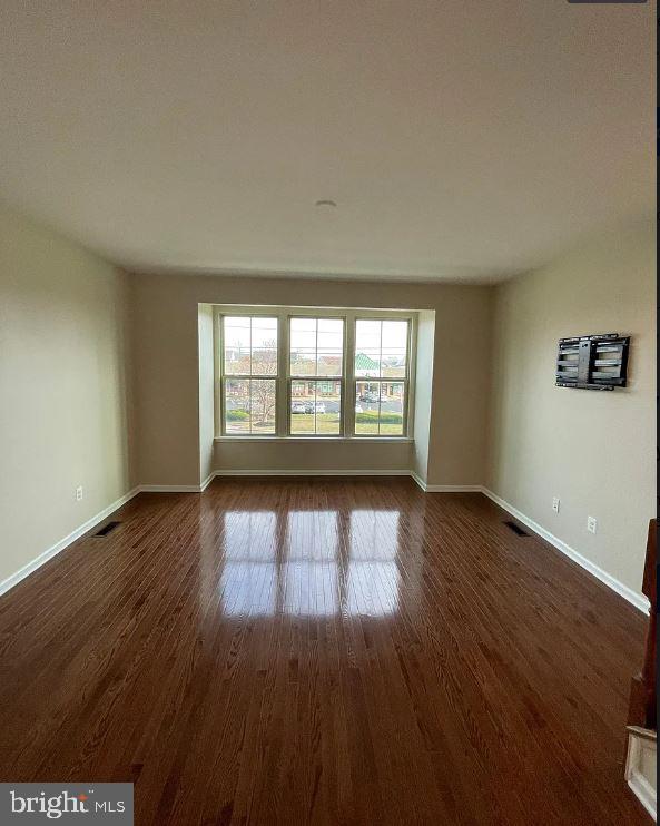 43855 Stubble Cor Square Ashburn, VA 20147 - Photo 8 of 38 an empty room with wooden floor and windows