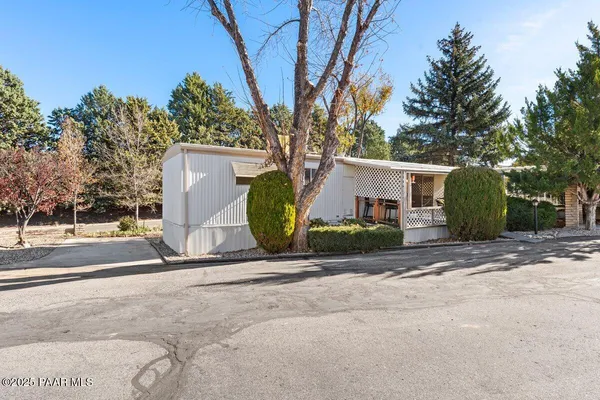 a view of a house with backyard and a tree